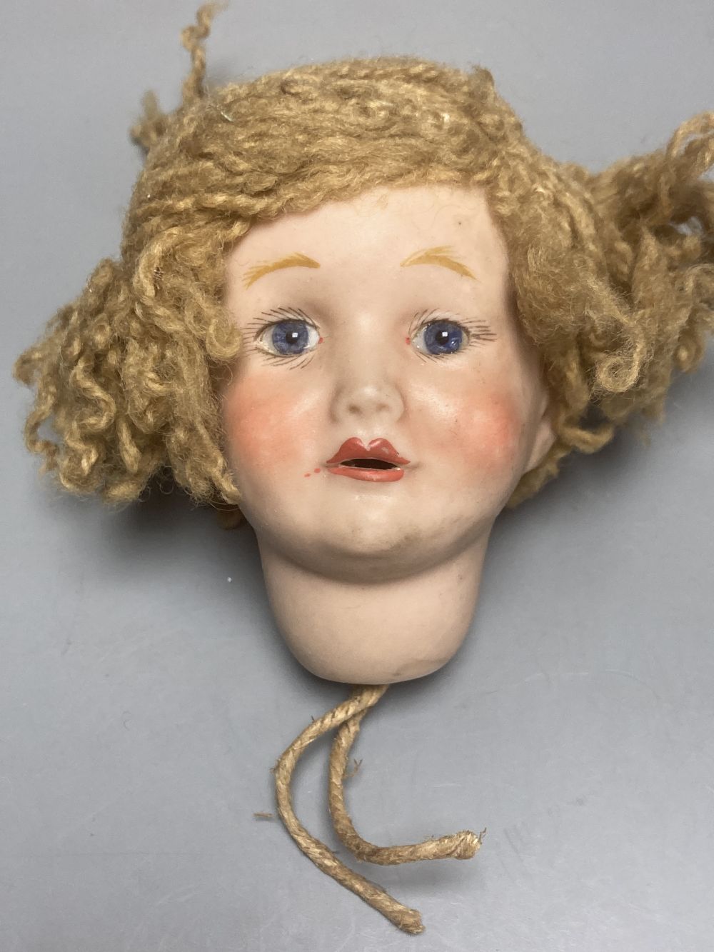 A Kammer & Reinhardt / Simon & Halbig bisque doll head, 10cm, three other German bisque doll heads and two English bisque doll heads,
